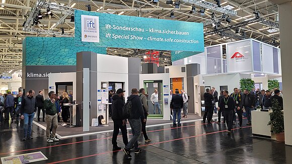 View of an exhibition stand with many people
