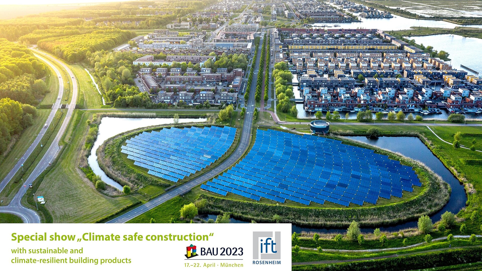 Large photovoltaic plant and housing estates surrounded by green landscape.  